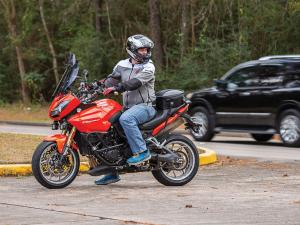 Photo of tail bag on bike - guy on motorcycle shot from left side