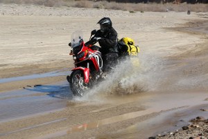 Africa Twin fully loaded with waterproof luggage in yellow