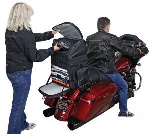 Photo of Destination on red Harley Davidson, man on motorcycle, woman removing item from bag