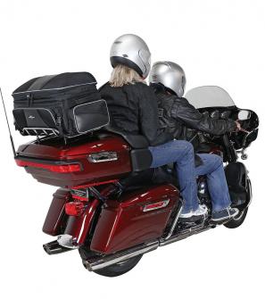 Photo of Traveler on red Harley Davidson trunk, man and woman on motorcycle
